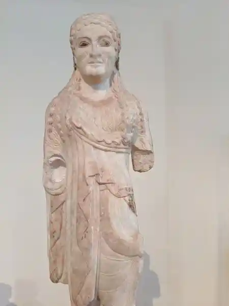 Marble kore statuette from the Acropolis wearing a chiton and ionic himation.